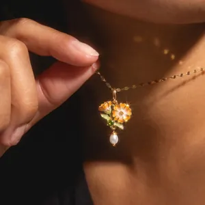 Close-up of an elegant floral bouquet necklace pendant with pearl and birthstone detail