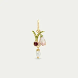 Close-up detail of floral birthstone pendant with pink enamel flower and white pearl