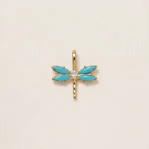 Detail view of 18K gold plated dragonfly pendant with blue and clear marquise stones