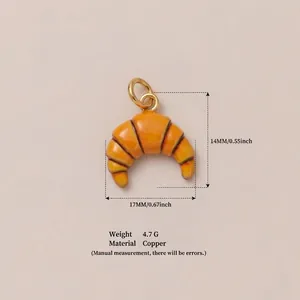 Close-up of a realistic orange croissant charm pendant with detailed dimensions and weight
