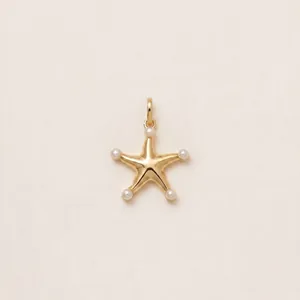 Detailed macro view of an 18K gold plated starfish pendant featuring five small pearls.
