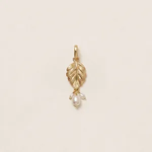 Macro view of an elegant 18K gold-plated leaf pendant with dangling white pearls