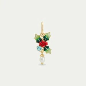 Detailed view of luxury gold holly leaf pendant with blue birthstone and white pearl drop