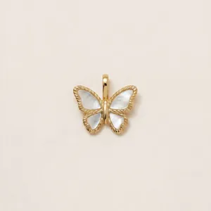 Detailed close-up of an elegant butterfly pendant with gold plating and white shell inlay