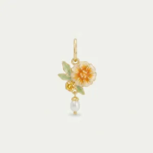 Close-up detail of a floral pendant featuring enamel petals, a yellow stone, and a pearl drop.