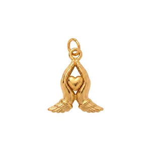Detailed macro view of a 18K gold plated stainless steel heart and angel wing pendant