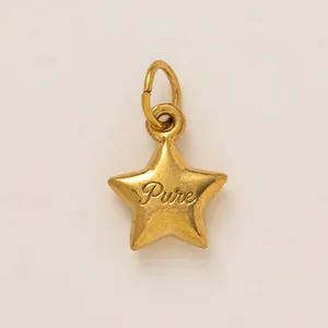 Close-up detail of a minimalist stainless steel star pendant with gold plating and Pure engraving