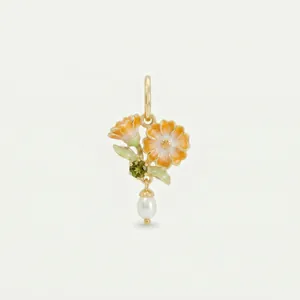 Detailed macro view of an elegant gold floral pendant with orange enamel and pearl.