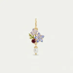 Close-up of a gold floral pendant featuring enamel flowers, garnet, and a white pearl drop.