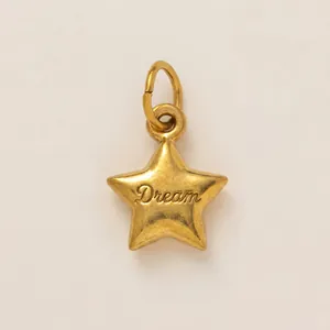 Detailed view of 18K gold plated stainless steel star pendant engraved with Dream