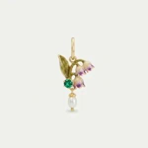 Close-up of lily of the valley pendant with green gemstone and white pearl drop