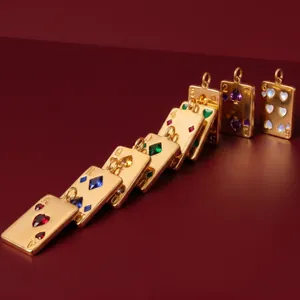 Golden playing card pendants with colorful crystal inlays shown in a macro detail shot