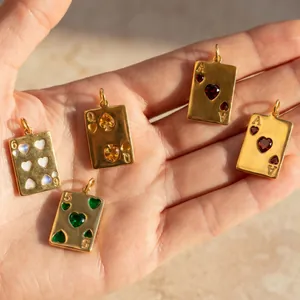 Detailed view of gold-plated stainless steel poker card pendants with colorful gemstones.