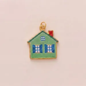 Detailed macro view of a green house-shaped enamel pendant with blue window details
