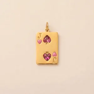 Detail showing gold poker card pendant with pink heart gemstones and J engraving