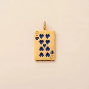 Close-up detail of a gold playing card pendant featuring nine blue heart shapes