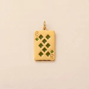Close-up detail of a 18K gold plated 8 of Diamonds playing card pendant with green stones.
