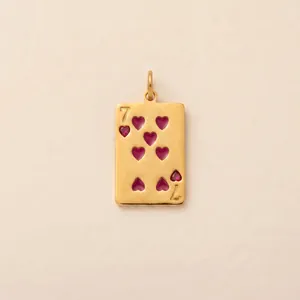 Close-up of golden stainless steel Seven of Hearts poker card pendant with red details