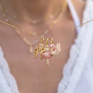 Detailed view of pink ballet-themed enamel charms including slippers and dancer