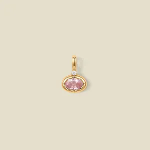 Macro detail view of gold plated stainless steel pendant featuring an oval pink gemstone