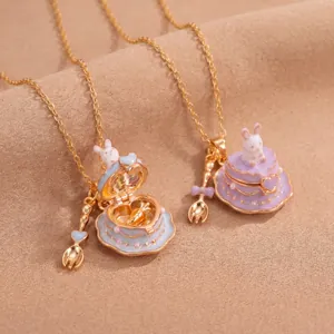 Detail view of a miniature rabbit cake locket necklace in macaron blue and purple finishes.