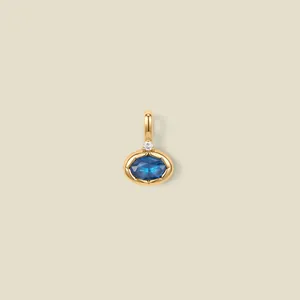 Detailed view of a gold plated pendant featuring a faceted oval blue gemstone setting.