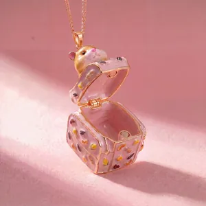 Detailed macro view of an openable pink enamel hamster suitcase pendant necklace