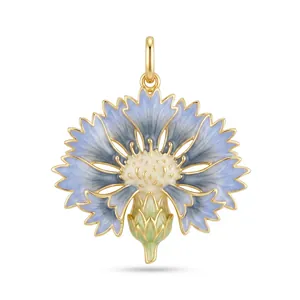 Detailed view of an elegant blue enamel cornflower pendant with gold metal finish