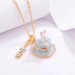 Close-up of a blue heart-shaped cake necklace pendant with a miniature rabbit