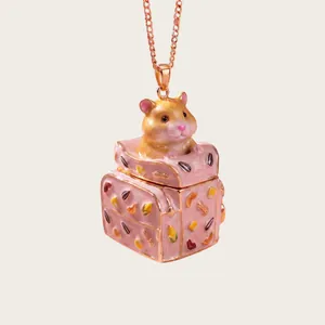 Macro view of a cute hamster emerging from a miniature pink patterned trunk pendant