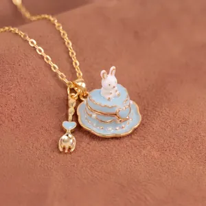 Detailed view of a miniature white rabbit on a light blue cake pendant necklace.