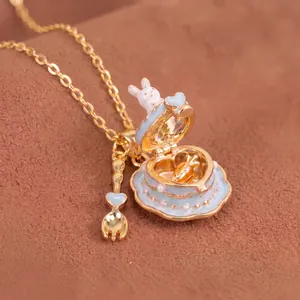 Detail of cute rabbit cake locket necklace with miniature fork charm and gold chain