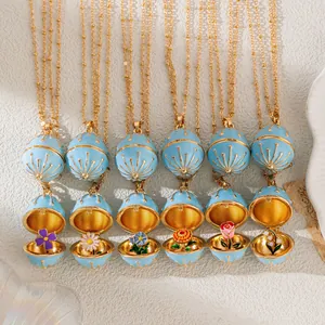 Vintage blue enamel egg locket necklaces with delicate flowers inside
