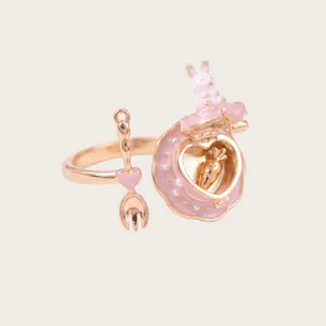 Detail showing a cute pink rabbit cake openable ring with a miniature carrot inside