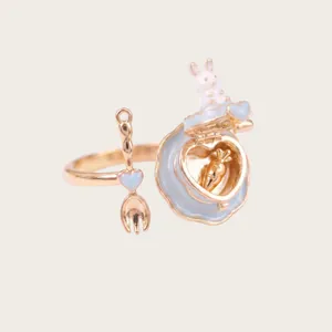 Close-up detail of healing miniature opening rabbit cake ring with carrot charm inside