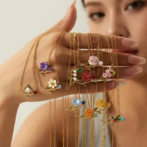 Vintage gold-plated necklaces featuring colorful enamel flowers of the twelve months