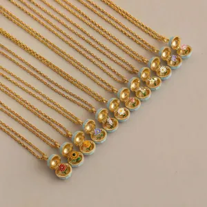 Collection of twelve distinct blue enamel birth flower locket necklaces in gold plating