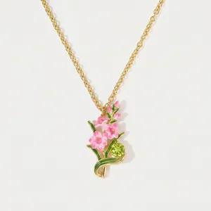 December birth flower necklace with pink enamel blossoms and green peridot gemstone