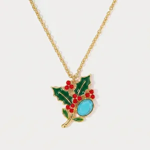 Detailed view of holly flower necklace with green enamel leaves and turquoise stone