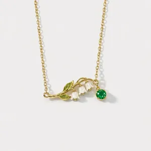 Elegant vintage gold-plated lily of the valley pendant necklace with green crystal