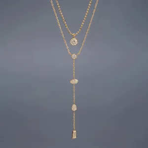 Elegant gold layered Y-necklace set featuring various stone cuts on a grey background