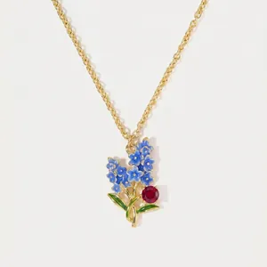 Exquisite gold forget-me-not flower necklace with blue enamel petals and red stone accent