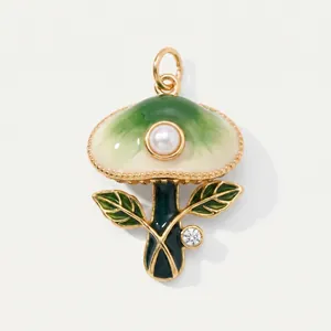 Close-up of a green and white enamel mushroom pendant with pearl and crystal details.