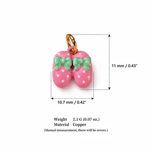 Detailed macro view of pink polka dot slipper charm pendant with size and weight info