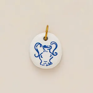 Elegant white ceramic pendant with blue amphora drawing and 18K gold plated bail accessory