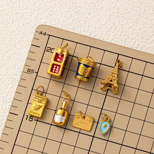 Assortment of vintage DIY jewelry pendants including Eiffel Tower and gold charms