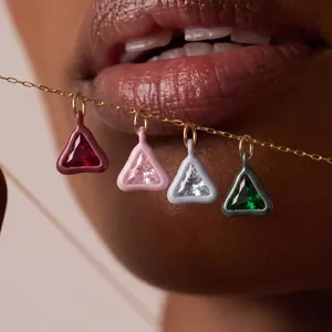 Artistic display of four colorful triangle stone pendants on an 18K gold plated chain