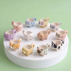 Variety of miniature cute cat and dog-shaped ceramic charms on a white display podium