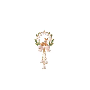 Detailed close-up of a floral wreath pendant with a cute deer and pink bow charm