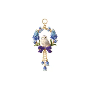 Detailed view of hand-painted enamel owl pendant with blue hyacinth wreath